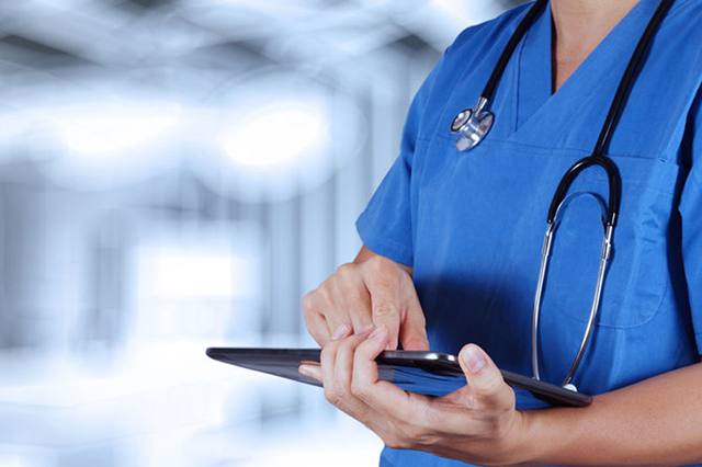 Practice nurse looking at electronic tablet